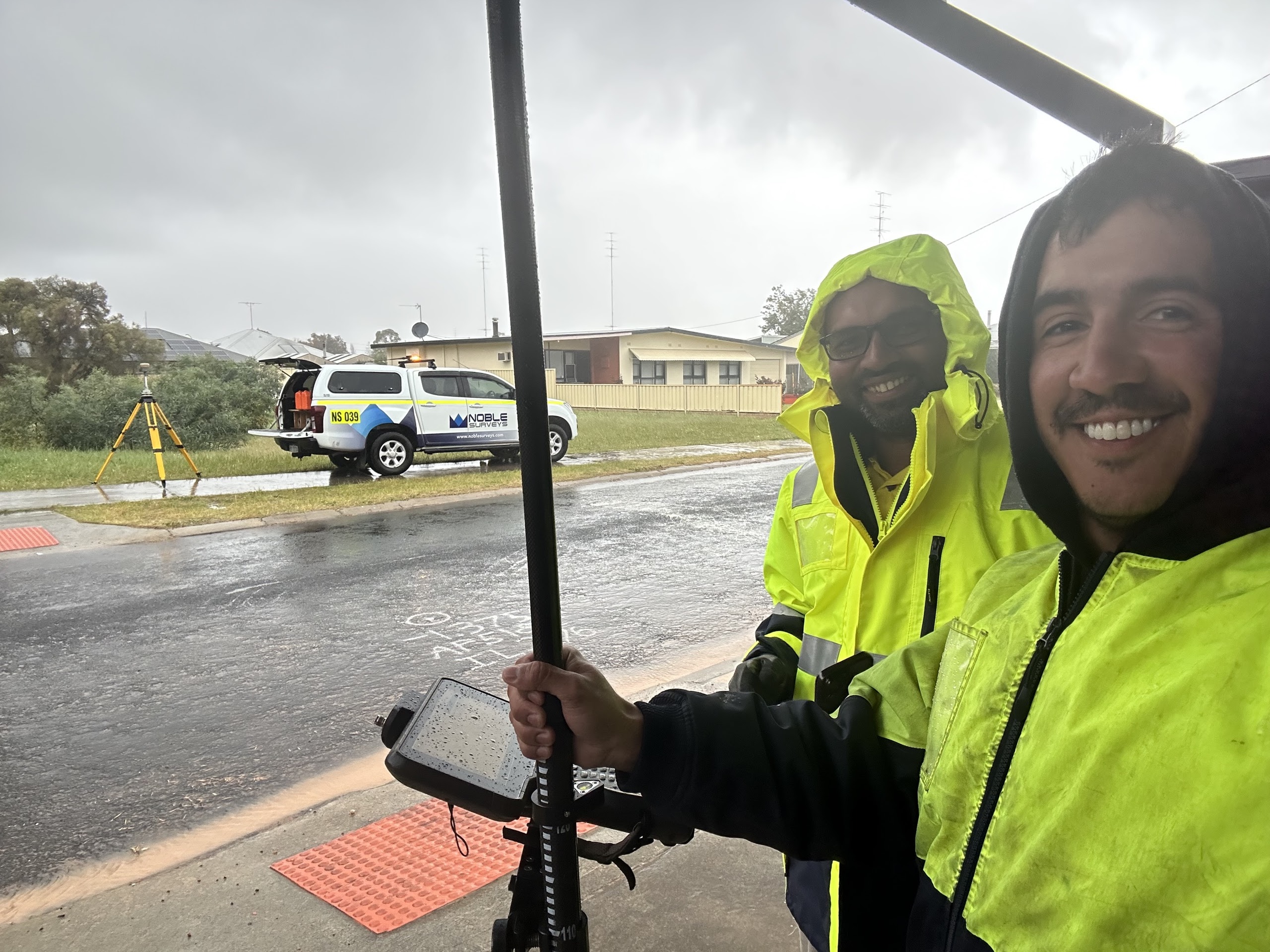 Strategic project planning session with advanced surveying equipment